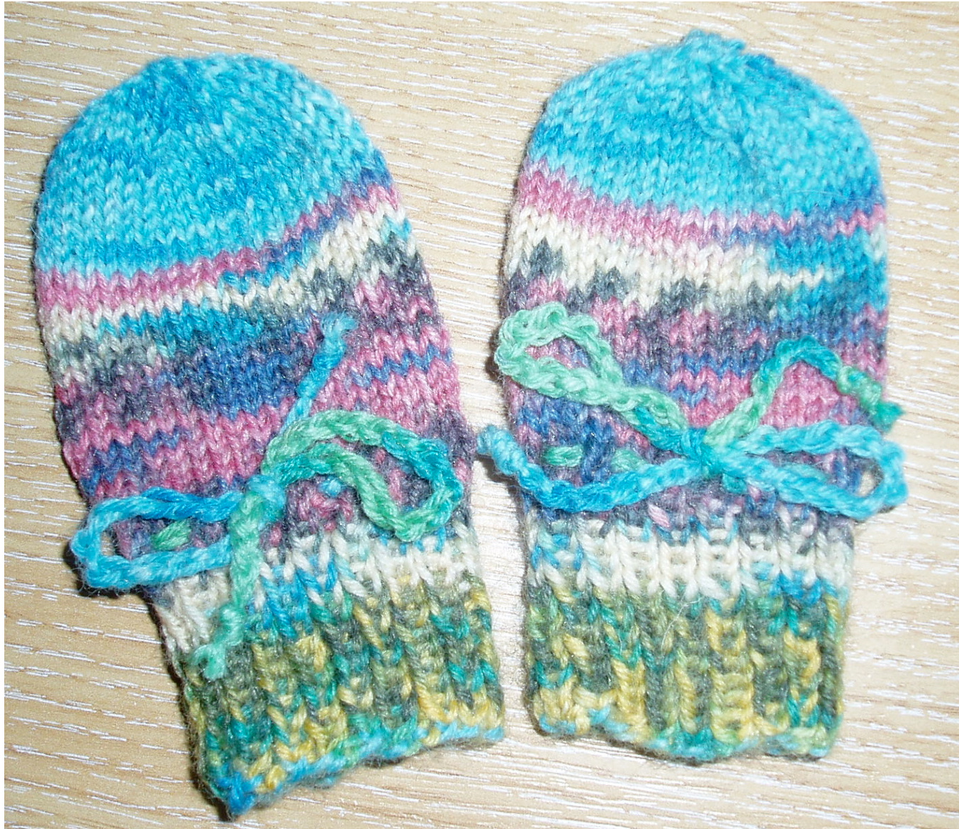 Crocheted Baby Mittens Pattern for Infants Up to Six Months Old with Ties and Self-Patterning Yarn pattern preview